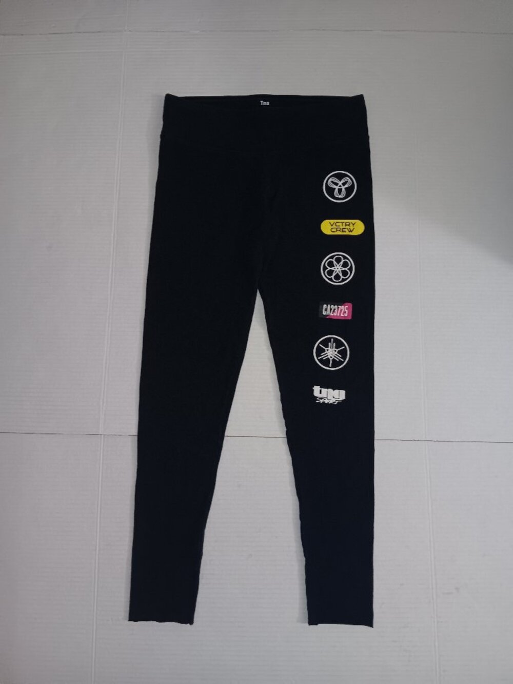 Tna by ARITZIA PATCHWORK MULTI LOGO LEGGINGS SIZE SMALL